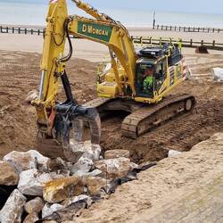 Rocks being carefully placed for sea defence