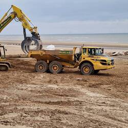 Rocks being loaded onto dumper trucks