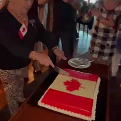 Pat Watt from Toronto cuts the cake