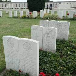 Adjoined graves means these soldiers were found in a mass grave together.