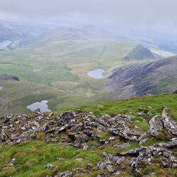 View towards distant Llyn Cwellyn lake. Snowdon Ranger route from here along the ridge on the right