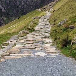 Half way along Llyn Llydaw path surface becomes laid large rocks as steeper ascent begins