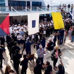 Staff and Crew join passengers on the pool deck — Aboard Insignia in Astoria, OR.