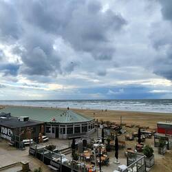 The wind swept beach. In the far distance you can see a wall of offshore wind turbines.