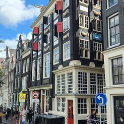 Building with red shutters is pretty and good slanted walls...