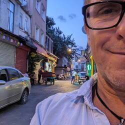 Over my shoulder, a guy moving a sofa on a little cart