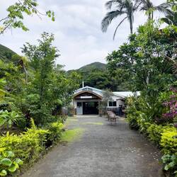Walking to the dyeing shed at Ōshima Tsumugimura — Amami Ōshima, Japan.