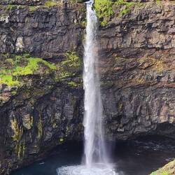 Mulafossur Waterfall with a tour boat for size comparison