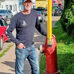 Fire hydrant has a tall flag so you can find it in the snow