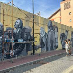 New mural with the artists looking on