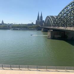 View of Cologne Cathedral and city waterfront.