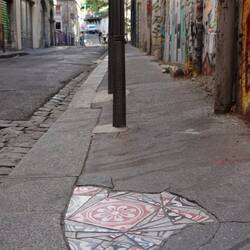 Ememem, guerilla artist who fills in city pot holes with mosaics