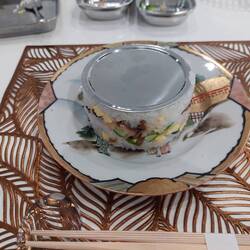 Turning the metal box of party sushi upside down