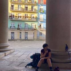 Cecile outside Pamplona cathedral taking a snack break