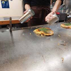Kelp and okonomiyaki sauce are added for the topping