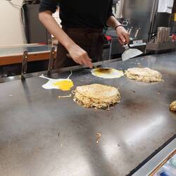 The egg is fridd next to the patty