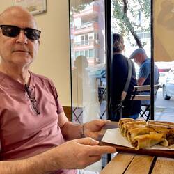 Deniz showing off his savory pastries ... eggplant and meat filling — Ülver Teyze ... Güzelyalı.