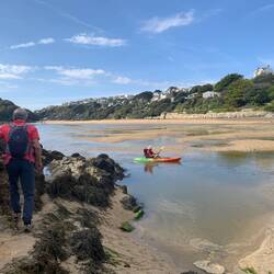 Kayaker making his way as the tide comes in