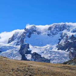 Clouds blowing over the top of the mountain and glaciers