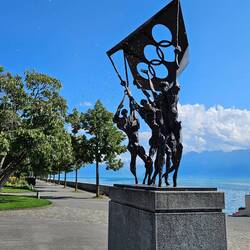 Statue in front of Olympic Museum on shore of Lake Geneva
