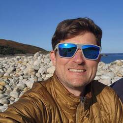 Rocky Talmine Bay Beach, with sand closer to the water