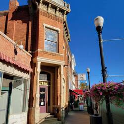 Main St sidewalk, Cowboy Cafe. You can see construction fencing to the right