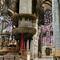 Baroque altar on left. Paintings, pillars, and magnificent stained glass