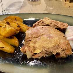 Pork peka (cooking slowly under an iron or clay bell covered in amber)