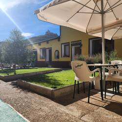 Albergue Orion courtyard woth a view to the ruins of a castle on the hill.