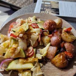 Fresh red potatoes, red onions, and tomatoes