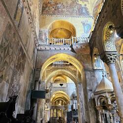 Marble slabs on walls, golden mosaics above