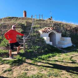 Pat in front of a Moratino family's wine bodega built into a hill.