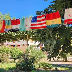 The plaza is lined with crochet flags of the world.