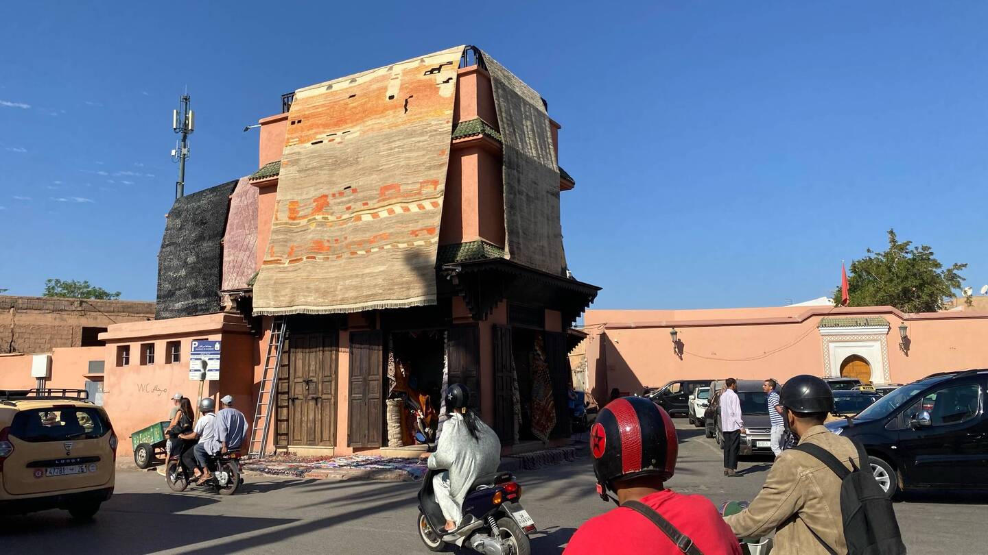 Massive rugs on display from the roof of a Rug store