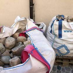 Bags of stones with flats cut to ready them for use.