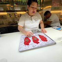 Beef carpaccio being prepared by Dominica