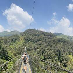 The long bridge in the leisure park leading to a waterfall