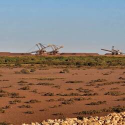 Enormous machines scooping up the enormous stockpile. These are controlled from Perth (1600 ks away)