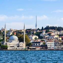 Asian coast of the Bosphorus with the Çamlıca Tower atop the hill — İstanbul, Türkiye.