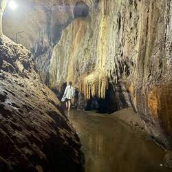 Paula walking along the path of the cave
