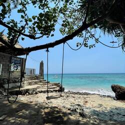 A swing at the tranquil beach access of the surf school at Senggigi Beach