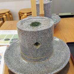 Stone mill to grind matcha powder from unrolled tencha-leaves grown in the shadow