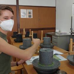 Grinding tencha-leaves in the stone mill to make matcha powder