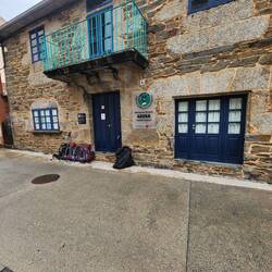 Backpacks holding places in line at the municipal albergue which doesn't take reservations.
