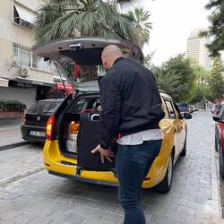 Mert, our usual taxi driver, loads up the car for the trip to ADB.