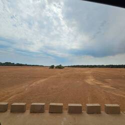 This isn't a vast plain, it's a huge, dry river bed.