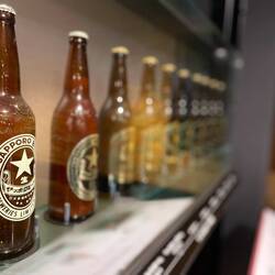 A long standing line of different Sapporo beers and labels over time