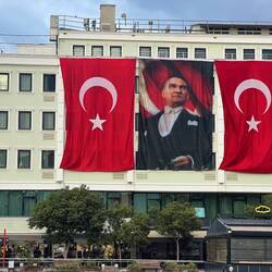 Flags of Türkiye and Mustafa Kemal Atatürk, founding father of the Republic of Türkiye