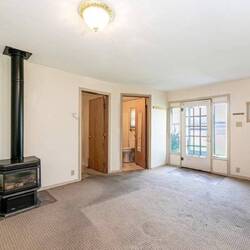 The ceilings were low and the room felt very small. Roxanne wanted to loft the ceiling.