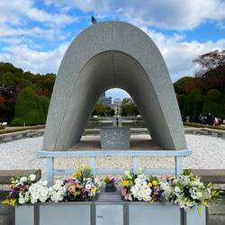 A pigeon on top of the "Victims Memorial Cenotaph" in Hiroshima